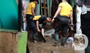 Anggota Polres Jember bantu warga bersihkan sisa luapan banjir